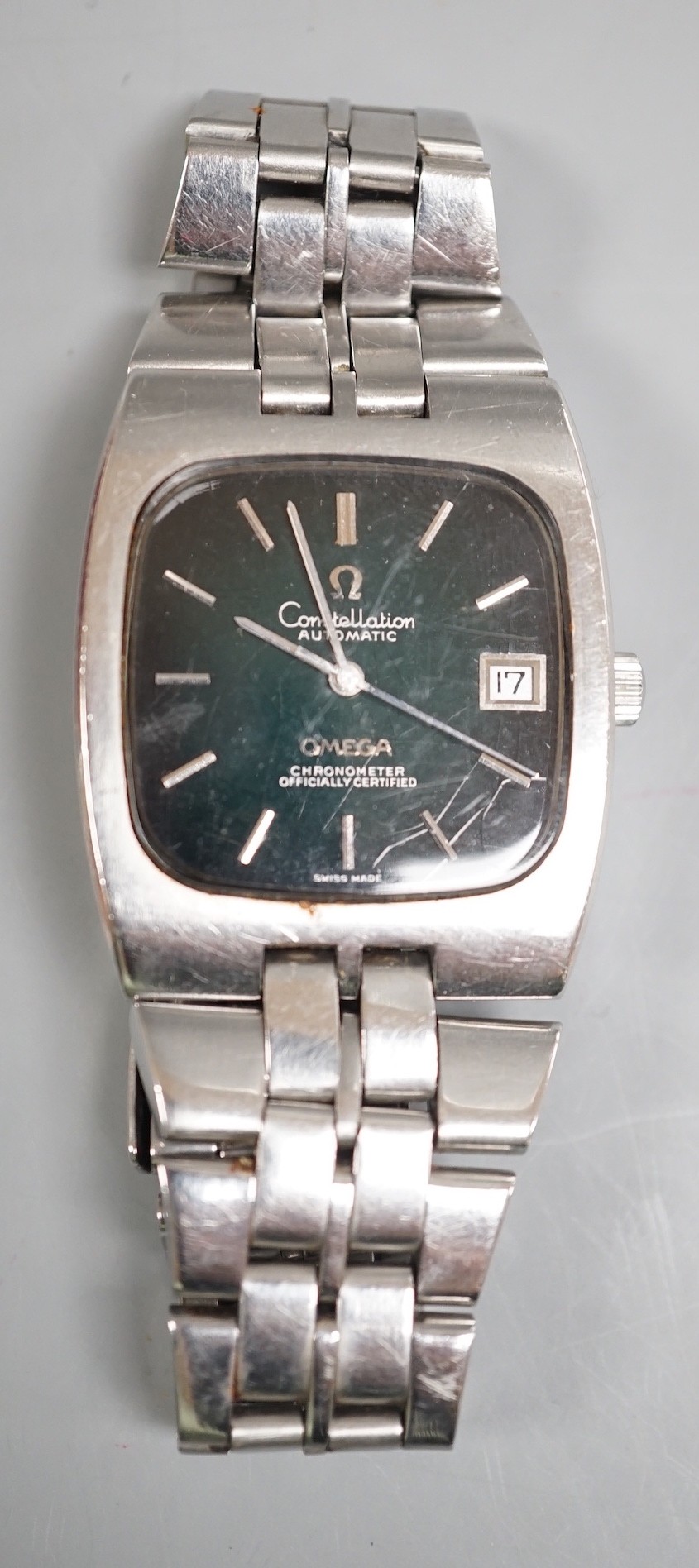 A gentleman's early 1970's stainless steel Omega Constellation chronometer black dial wrist watch, with bate numerals and date aperture, on stainless steel Omega bracelet, case diameter 33mm, with Omega box.